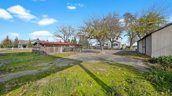 a view of yard with swimming pool and sitting area