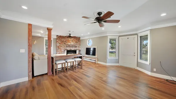 a view of a livingroom with furniture and hardwood floor