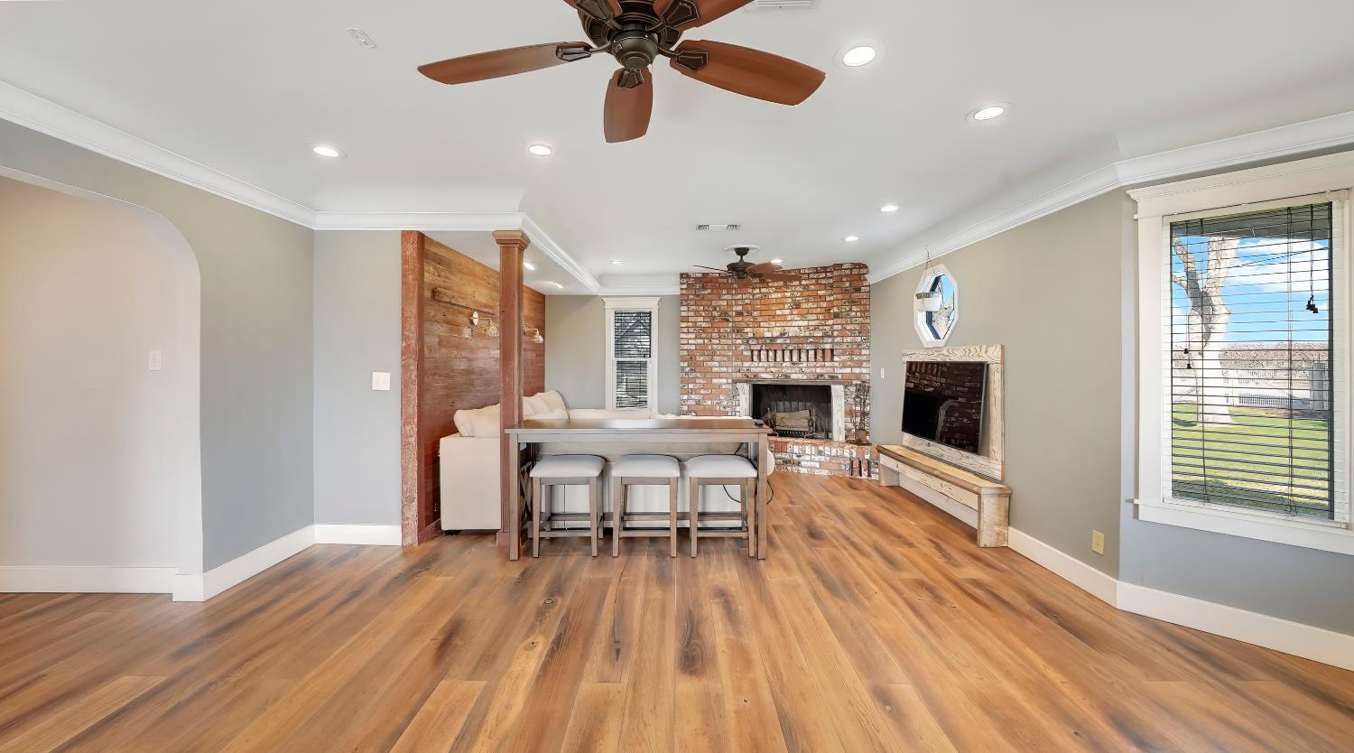 41709 Road 52 Reedley, CA 93654 - Photo 23 of 52 a view of a livingroom with furniture a ceiling fan and wooden floor