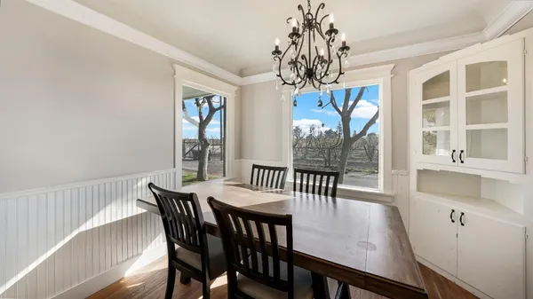a view of a dining room with furniture window and wooden floor