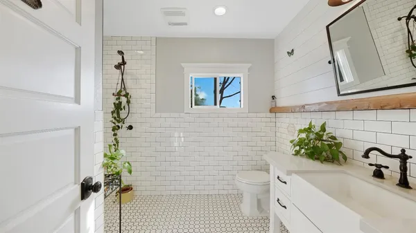 a bathroom with a sink toilet and shower