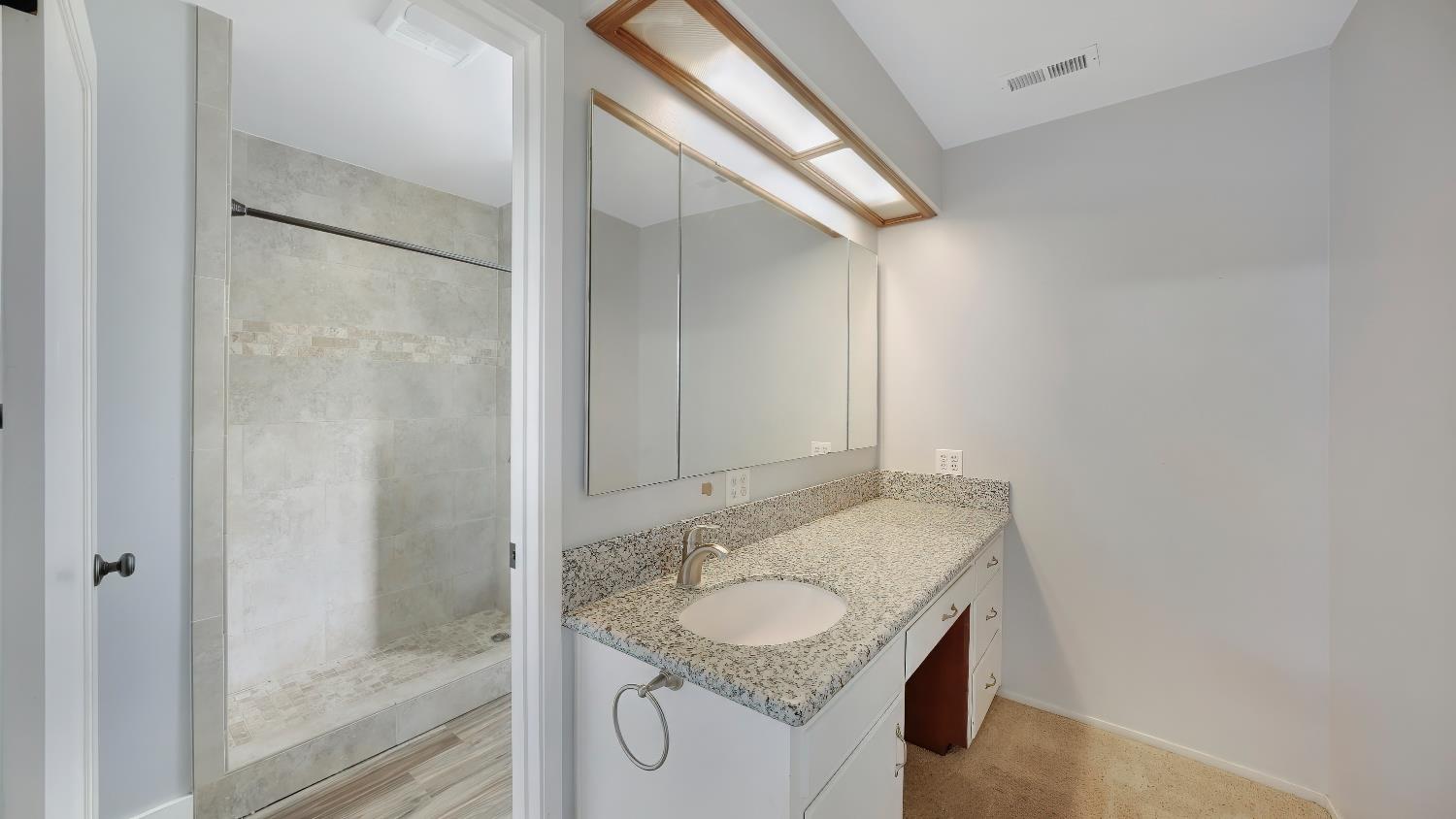 41709 Road 52 Reedley, CA 93654 - Photo 43 of 52 a bathroom with a granite countertop sink and a mirror