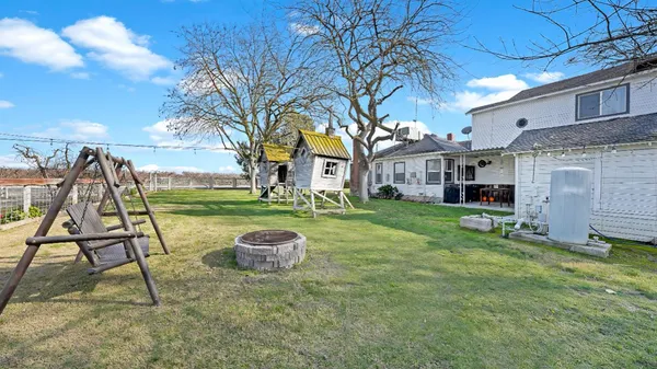 a view of a house with a backyard