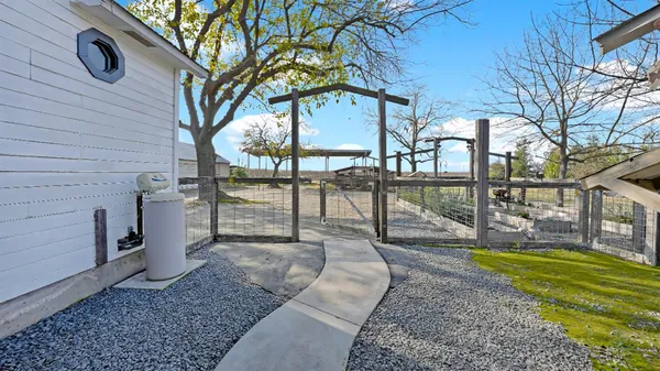 a view of a house with backyard and sitting area