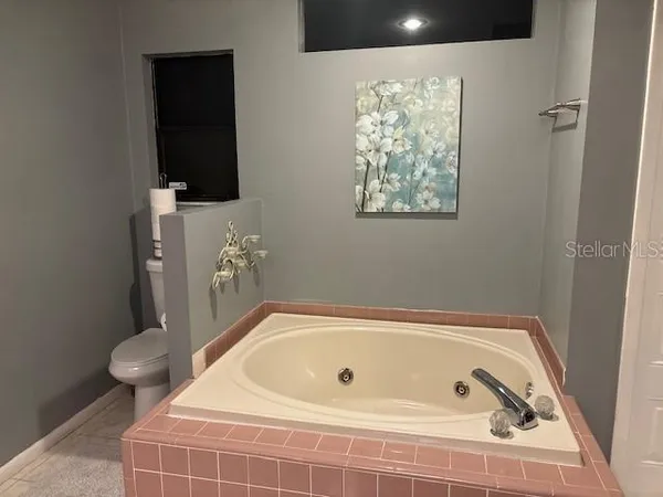 a bathroom with a bathtub and toilet