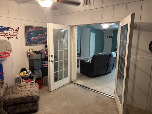 a view of a livingroom with closet and a couch