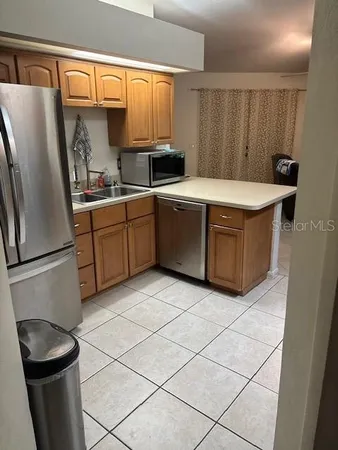 a kitchen with stainless steel appliances a refrigerator sink and cabinets