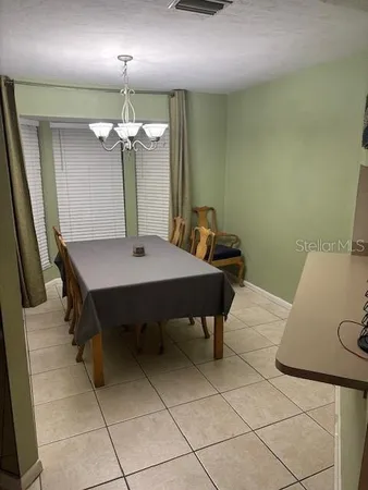 a dining room with furniture and window
