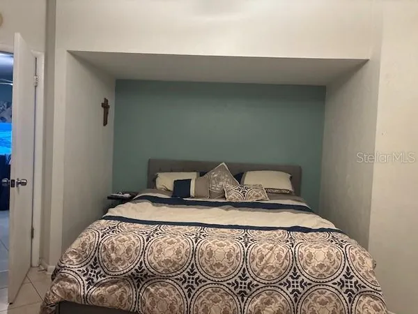 a bedroom with a bed and window