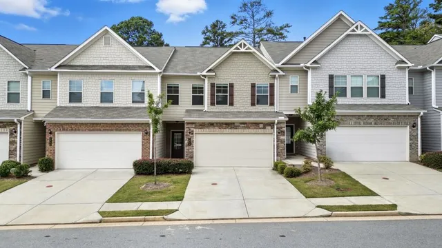 a kitchen with stainless steel appliances granite countertop a stove top oven a sink dishwasher and a microwave oven with white cabinets