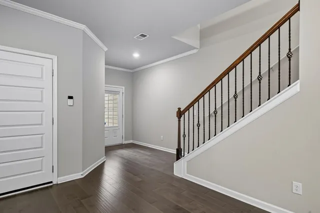 a kitchen with stainless steel appliances granite countertop a refrigerator a stove top oven a sink and dishwasher