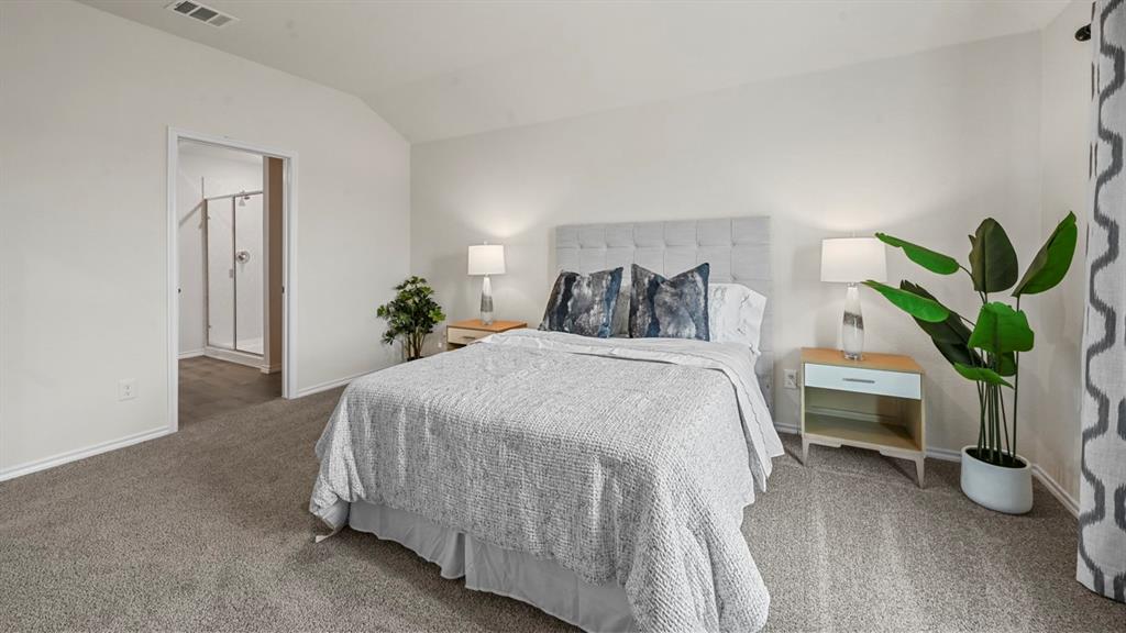 412 Wild Rose Way Princeton, TX 75407 - Photo 21 of 33 a bedroom with a bed and a potted plant