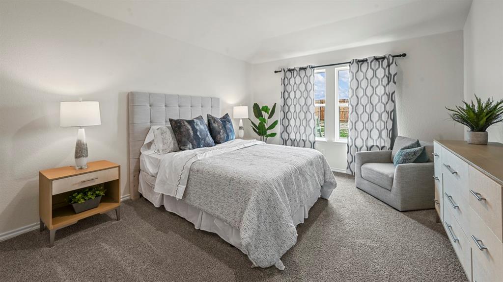 412 Wild Rose Way Princeton, TX 75407 - Photo 23 of 33 a bedroom with a bed and a couch