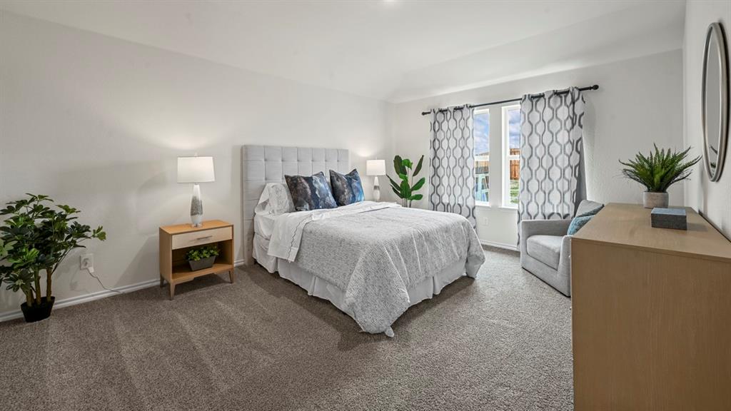 412 Wild Rose Way Princeton, TX 75407 - Photo 24 of 33 a bedroom with a bed and a potted plant