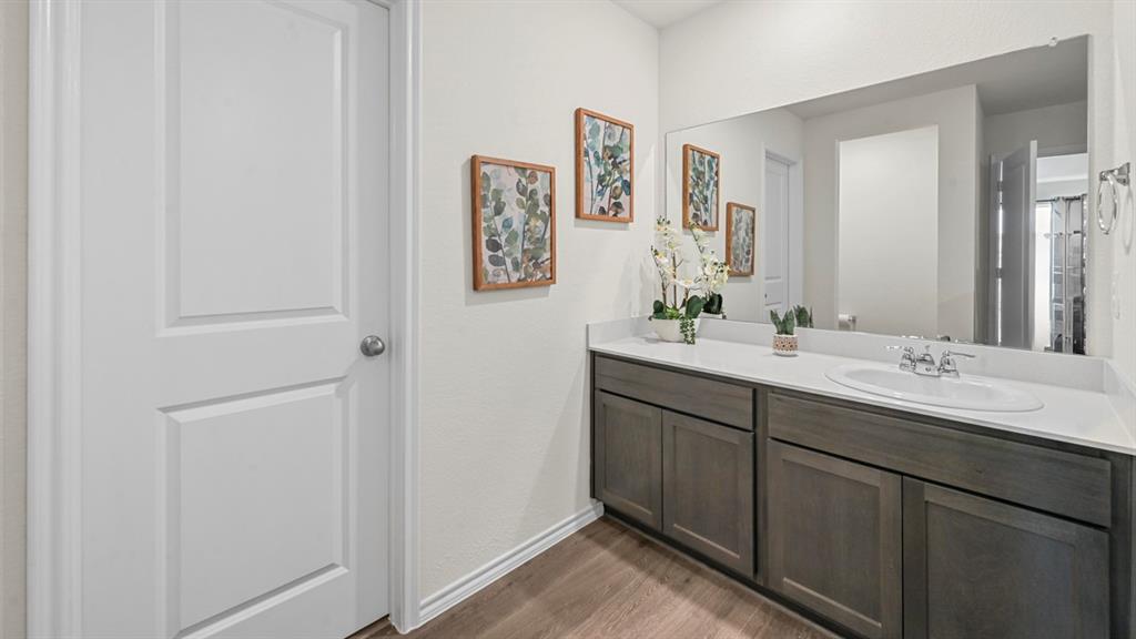 412 Wild Rose Way Princeton, TX 75407 - Photo 30 of 33 a bathroom with a double vanity sink and a mirror