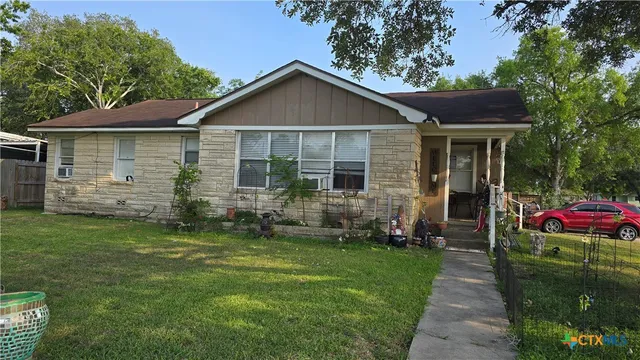 a front view of a house with a garden