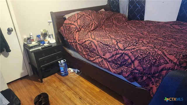 a bed sitting in a bedroom next to a window