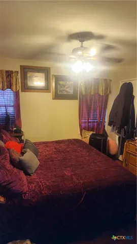 a bed sitting in a room next to a lamp