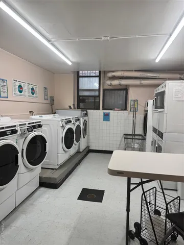 a kitchen with a stove a microwave and white cabinets