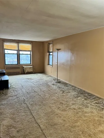 a view of empty room with a fireplace