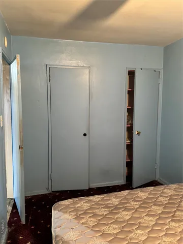 a bedroom with a bed and a mirror