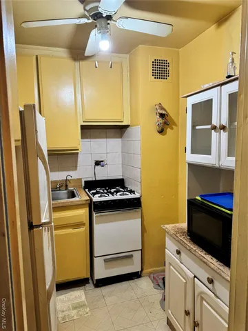 a kitchen with stainless steel appliances granite countertop a stove a refrigerator and a microwave