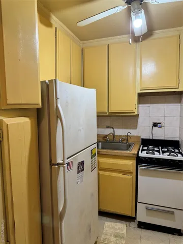 a kitchen with a refrigerator and a stove