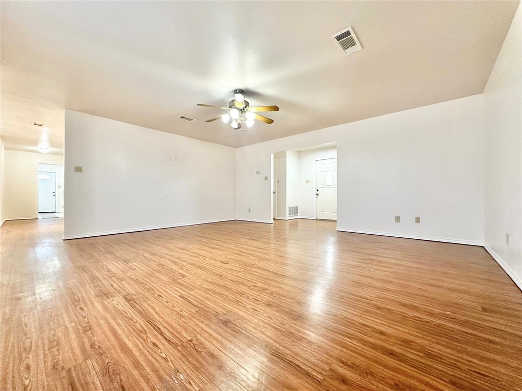 8869 Liberty Road Aubrey, TX 76227 - Photo 3 of 25 wooden floor in an empty room with a window