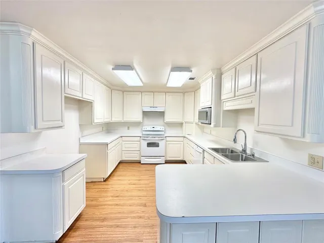 a kitchen with stainless steel appliances granite countertop a sink and cabinets