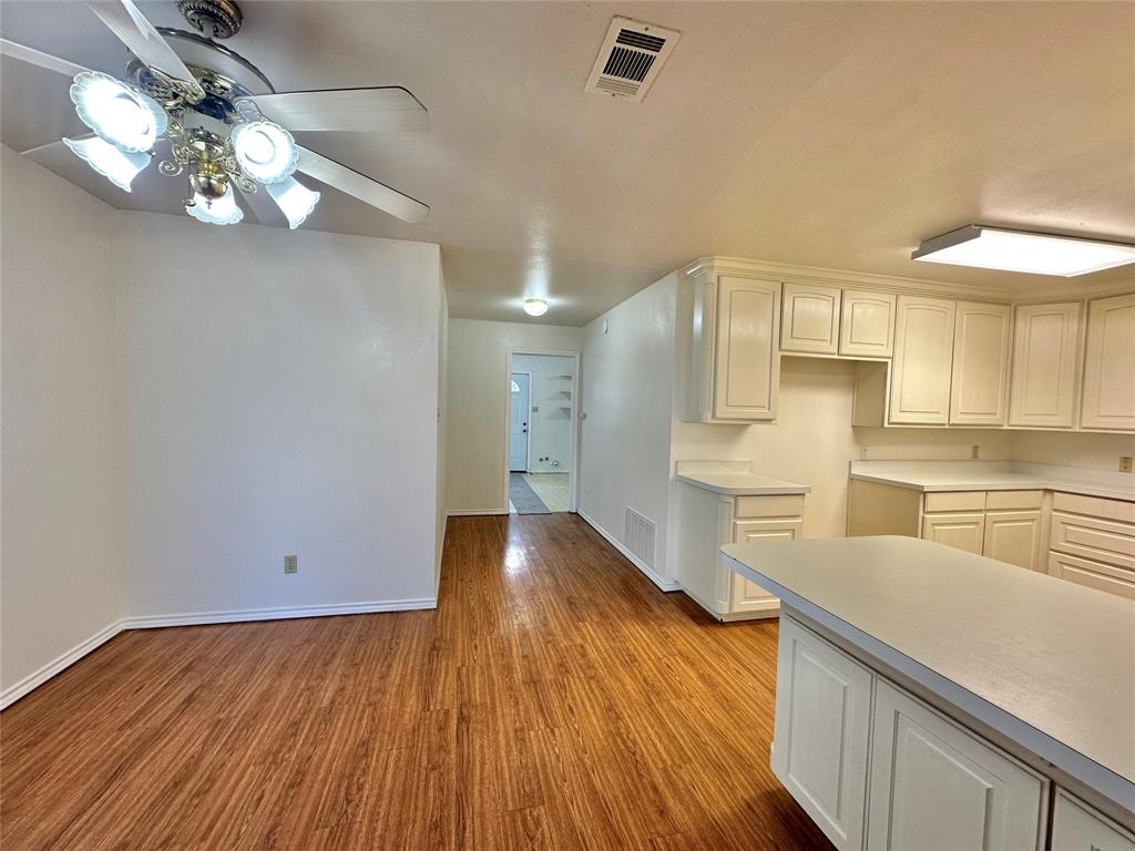 8869 Liberty Road Aubrey, TX 76227 - Photo 8 of 25 a view of a kitchen with wooden floor and a kitchen