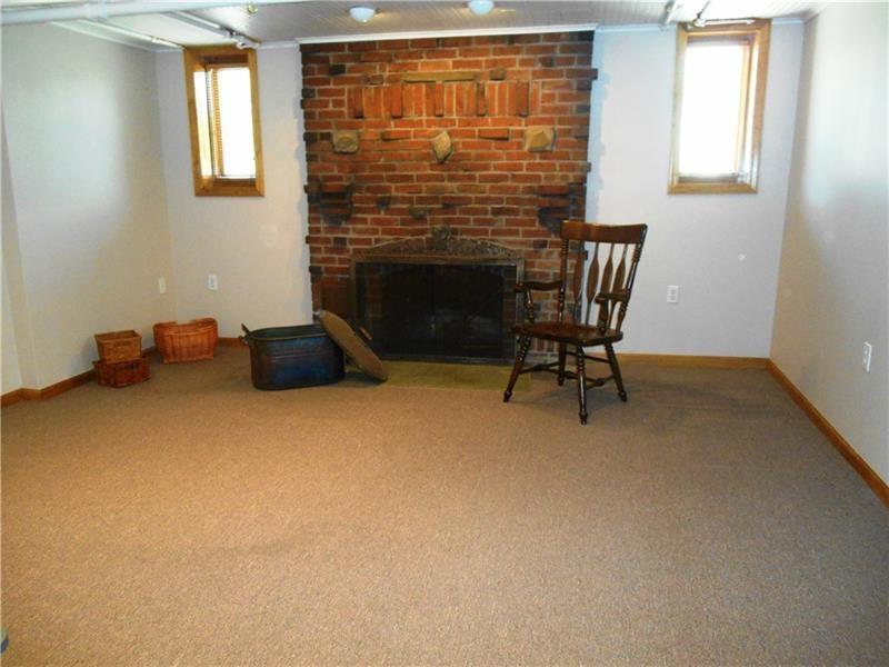 235 Cochran Road Pittsburgh, PA 15228 - Photo 20 of 25 Lower level game room with barber carpet and a log burning fireplace.