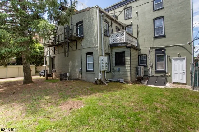 an aerial view of residential houses with outdoor space and river