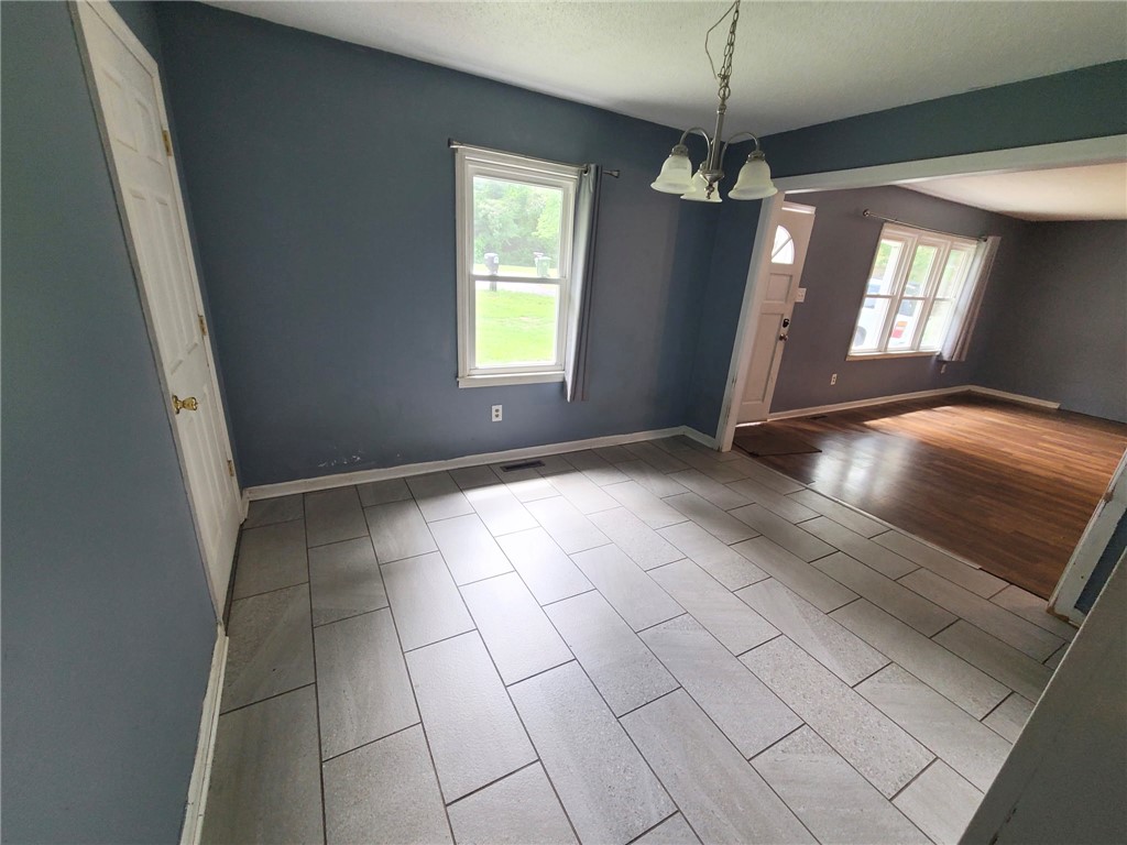 110 Ridgemont Court Greenwood, SC 29649 - Photo 3 of 14 An inviting dining area features elegant tile flooring and an open flow to the adjacent living space.