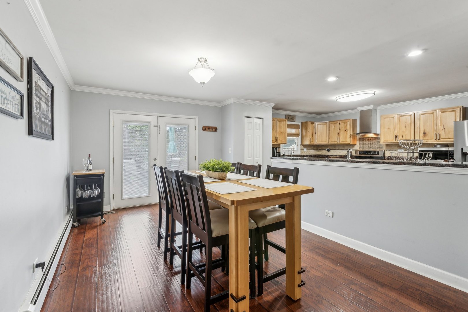 204 Oakleaf Road Lake In The Hills, IL 60156 - Photo 7 of 41 a kitchen with stainless steel appliances granite countertop a stove a sink a refrigerator with a dining table and chairs