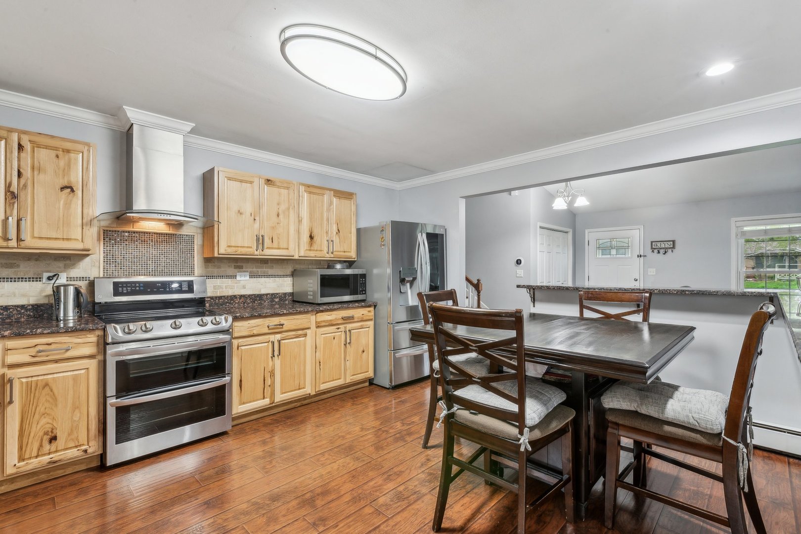 204 Oakleaf Road Lake In The Hills, IL 60156 - Photo 9 of 41 a kitchen with a table chairs stove and cabinets