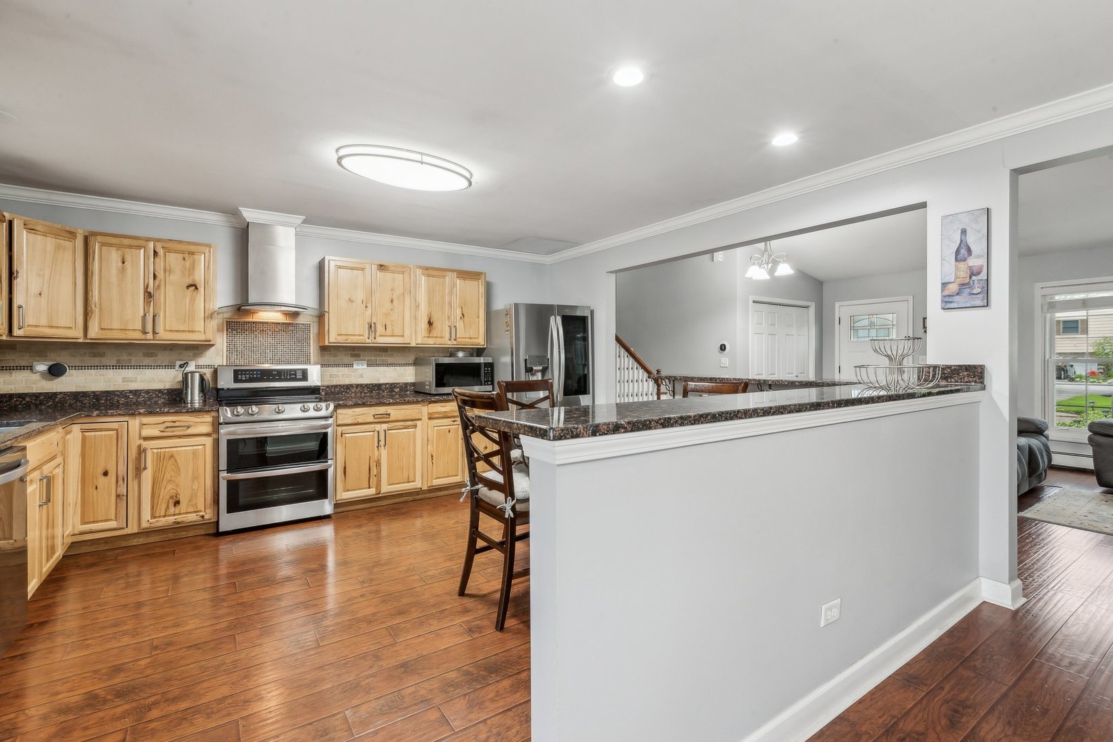 204 Oakleaf Road Lake In The Hills, IL 60156 - Photo 10 of 41 a kitchen with granite countertop a refrigerator stove top oven and cabinets