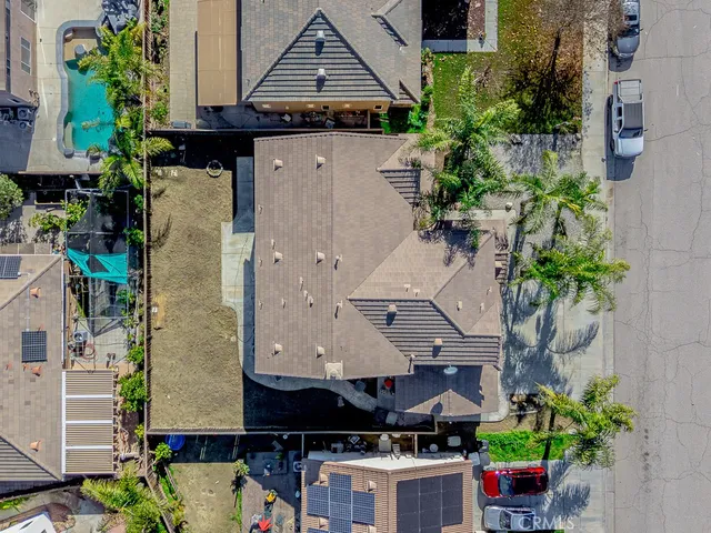 an aerial view of a city with lots of residential buildings ocean and mountain view in back