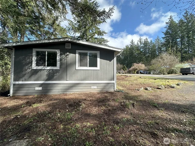 a view of backyard with wooden fence