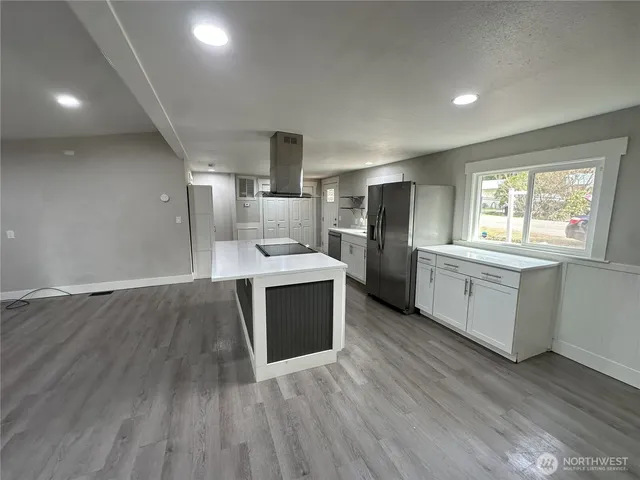 a kitchen with stainless steel appliances a stove a sink and a refrigerator