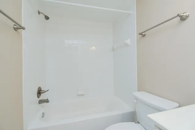 a bathroom with a bathtub and a toilet