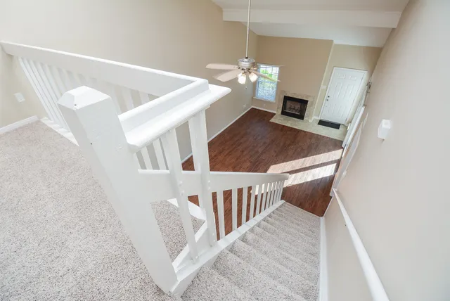 a view of a livingroom with wooden floor and chandelier