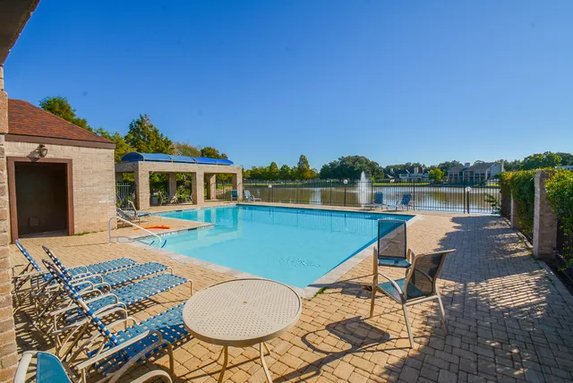 a view of a patio with table and chairs with wooden floor and fence