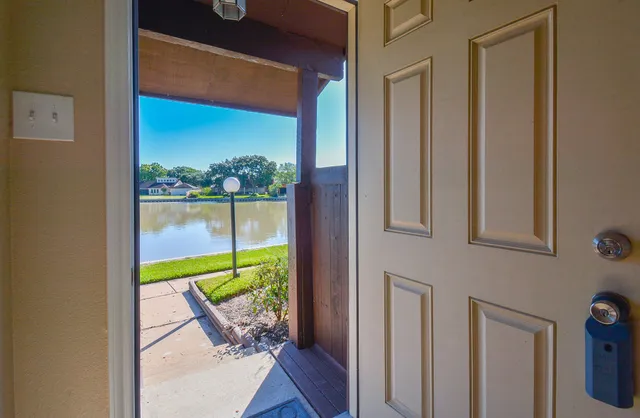 a view of a two room with a large window and front door