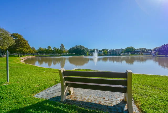 a view of a lake with houses in the back