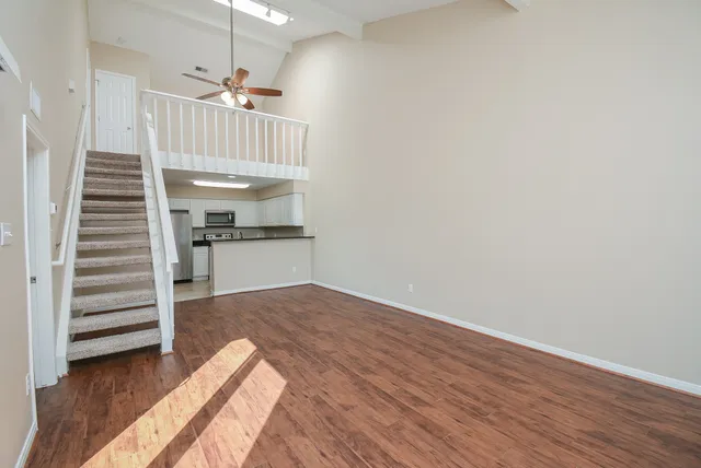 a view of a room with wooden floor and staircase