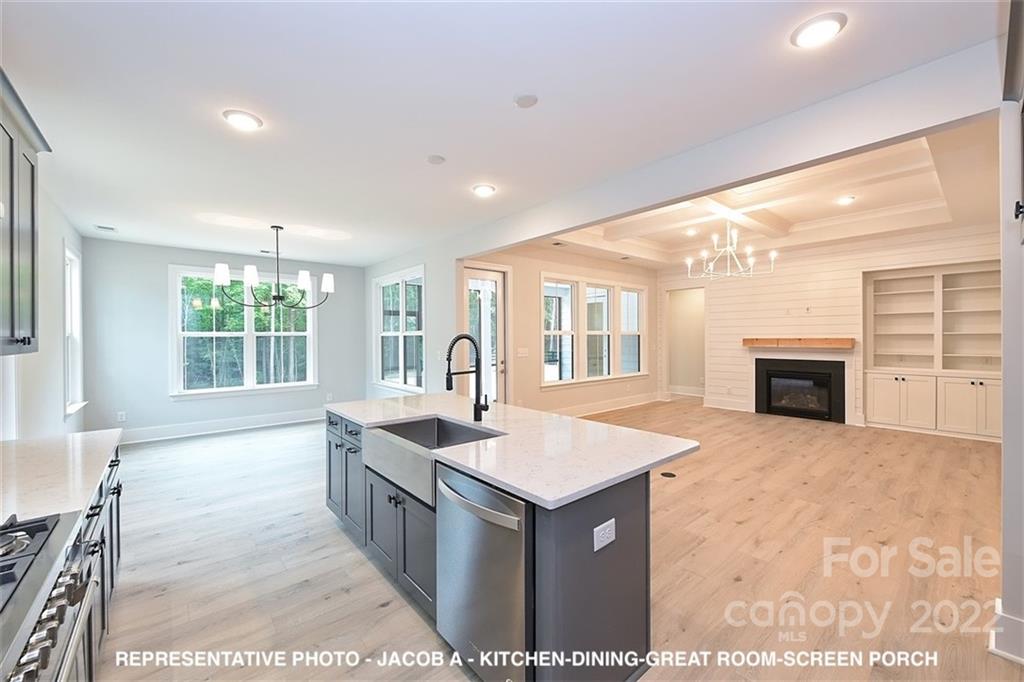 366 Meek Road Gastonia, NC 28056 - Photo 12 of 24 a hall with kitchen island a sink wooden floor and a fireplace