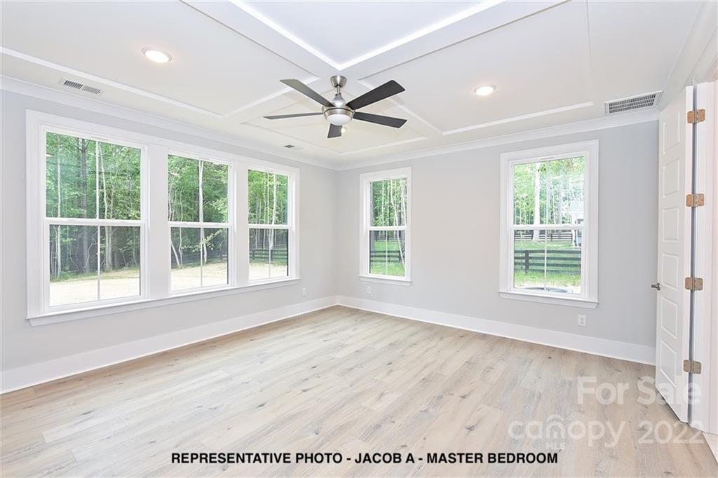 366 Meek Road Gastonia, NC 28056 - Photo 15 of 24 a view of an empty room with a window and wooden floor