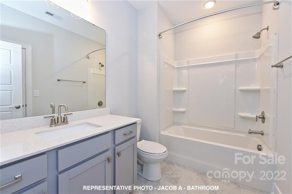 366 Meek Road Gastonia, NC 28056 - Photo 20 of 24 a bathroom with a sink toilet a shower and a mirror