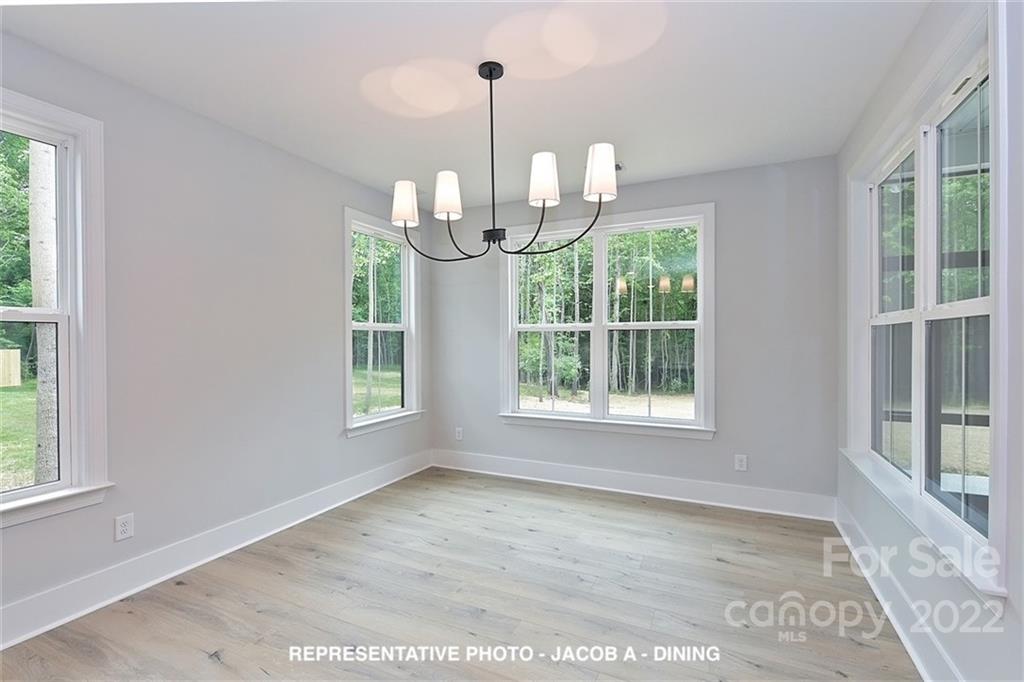 366 Meek Road Gastonia, NC 28056 - Photo 9 of 24 a view of empty room with wooden floor and fan