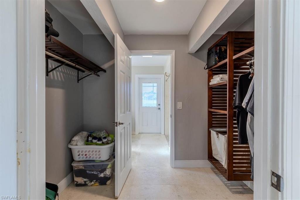 4590 Eagle Key Circle Naples, FL 34112 - Photo 16 of 37 View of walk in closet in primary bedroom